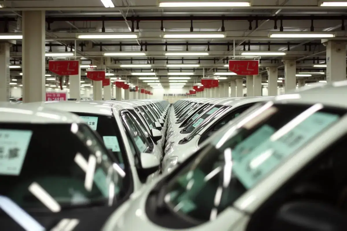 Rows of vehicles at a Japanese auto auction, inspected in person before bidding